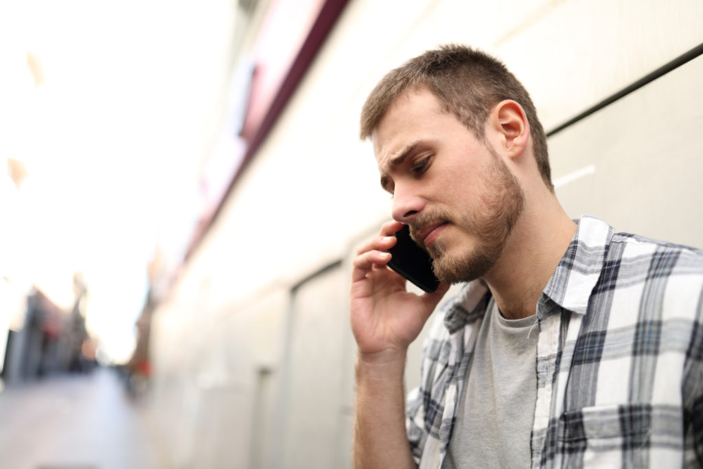 Sad man with phone